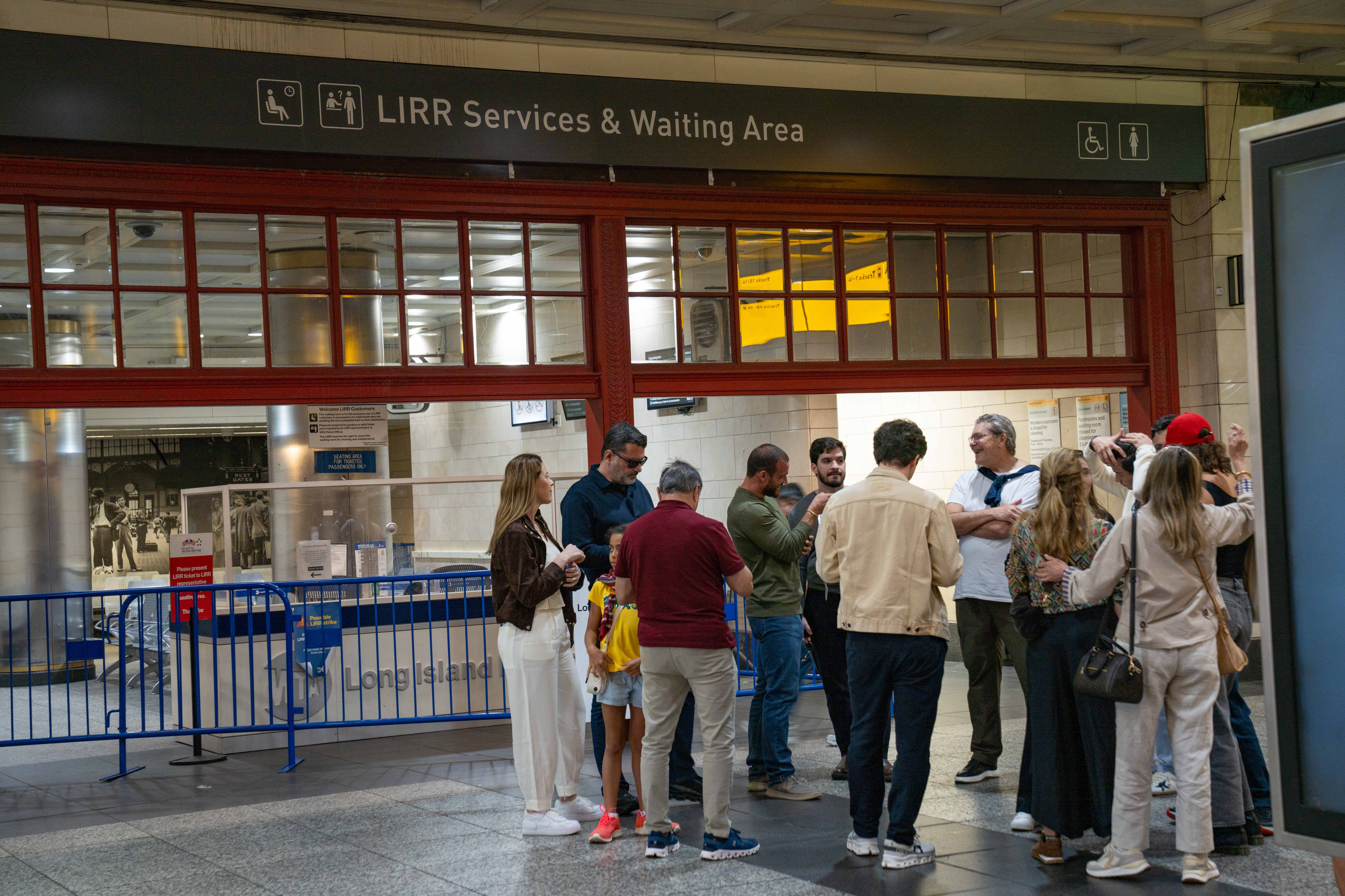 Stranded riders standing next to the waiting area at the...