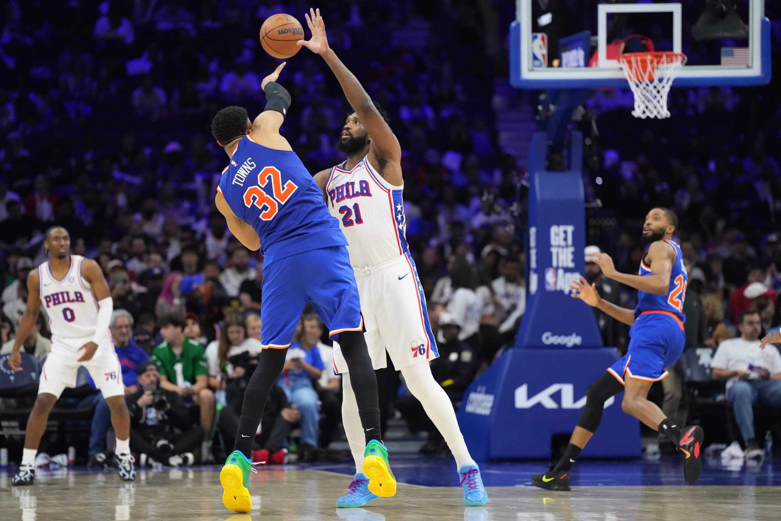 Karl-Anthony Towns passes the ball past Joel Embiid, and Mikal Bridges scores in the third quarter for one of Towns' 10 assists in Game 4. (Kyle Ross / Imagn Images)