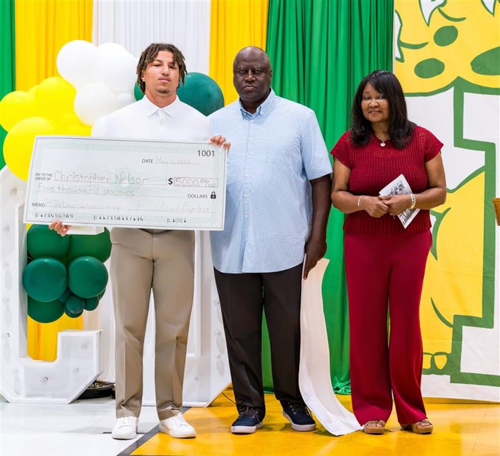 Christopher Nelson receives one of Patrick Queen's inaugural athletic scholarship awards for...