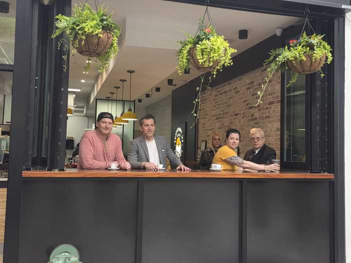 Jason Potter (left) and Mircea Pirvu (center left) at the newly-opened Sunnyside Up Café. Photo by Shane O'Brien.
