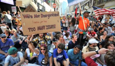 Demonstrators with "Occupy Boston" stop on Washington Street during a march through  Boston, Monday afternoon, Oct. 10, 2011.