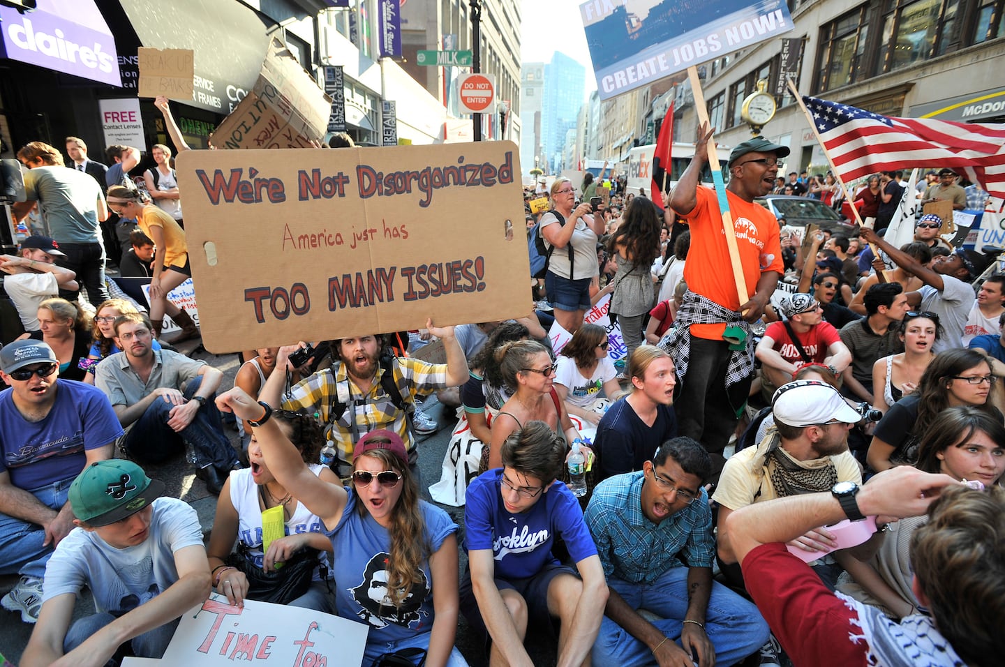 Demonstrators with "Occupy Boston" stop on Washington Street during a march through  Boston, Monday afternoon, Oct. 10, 2011.