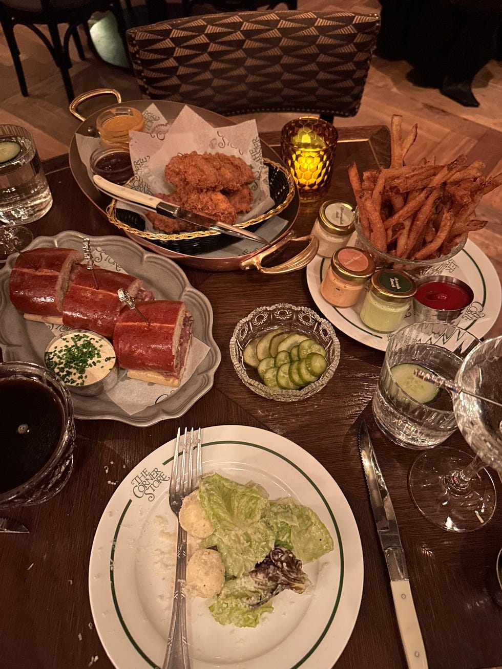 Dinner spread featuring fried chicken, salad, and sweet potato fries. Dinner spread featuring fried chicken, salad, and sweet potato fries.
