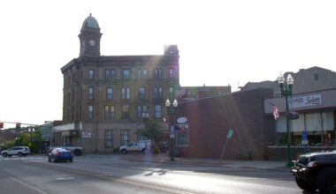 a clock-tower building along a street in auburn new york at daytime