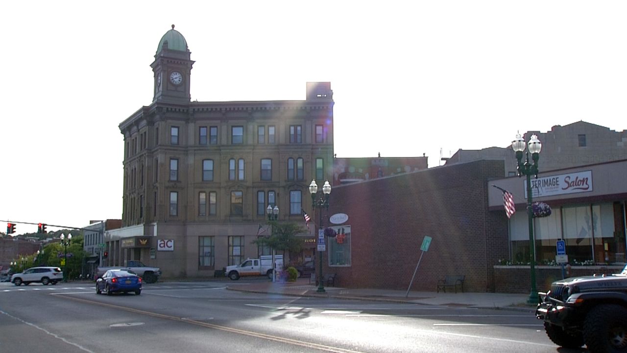 a clock-tower building along a street in auburn new york at daytime