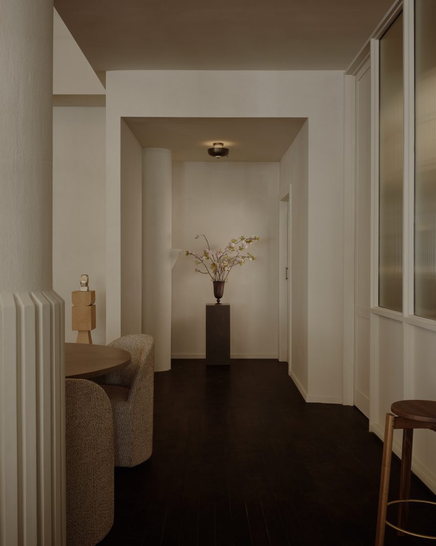 Soft, warm beige walls contrast dark-stained wooden floors