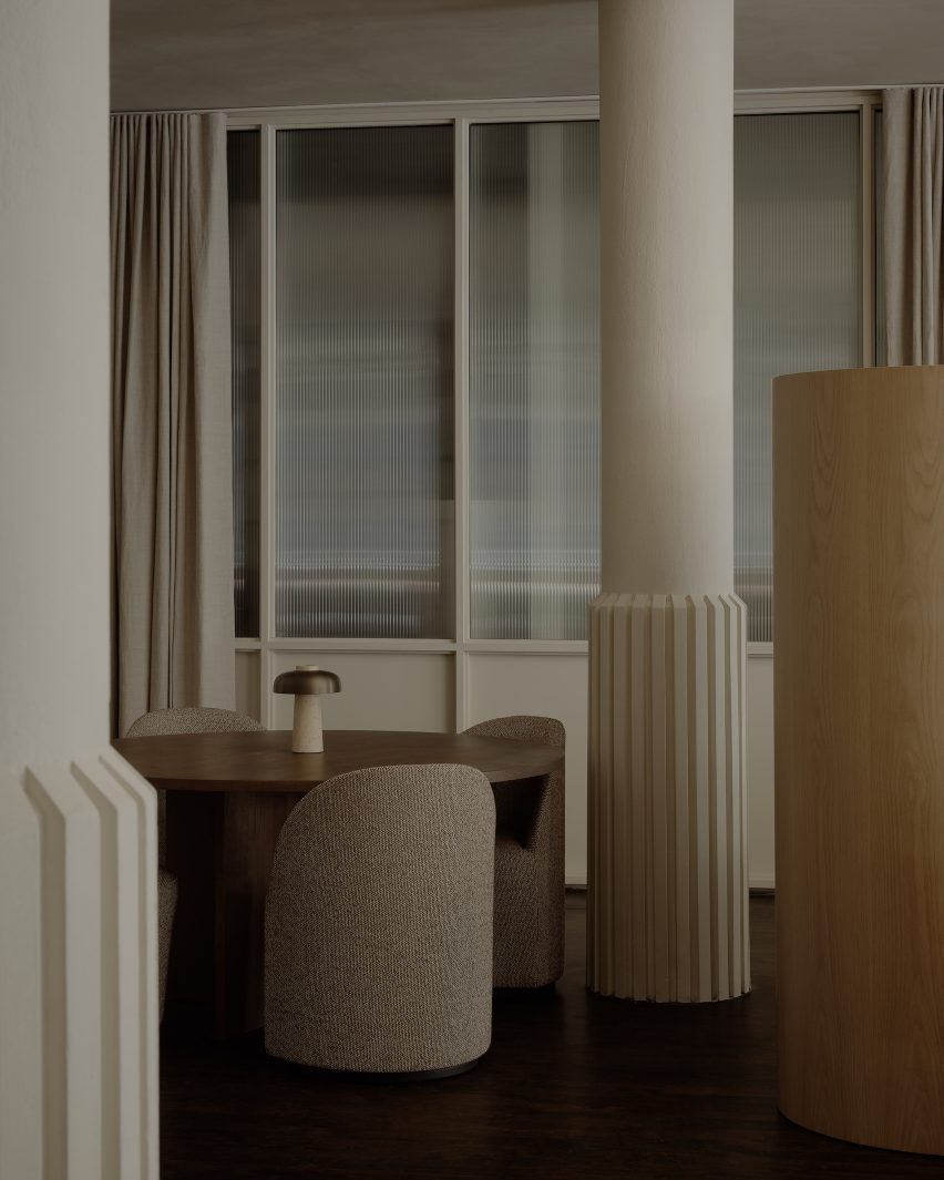 Structural columns wrapped in ridged flares around their bases