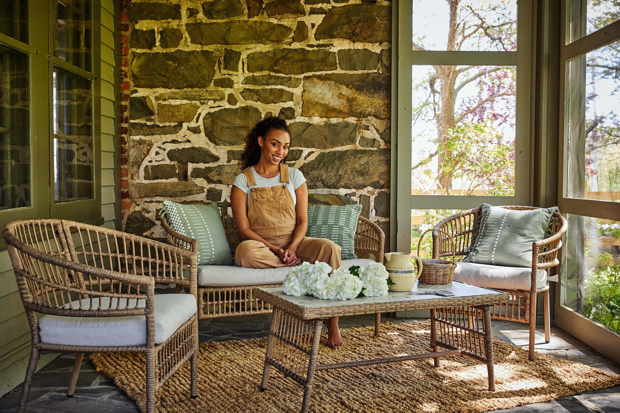 Cozy sitting area with a person in casual attire among rustic décor.