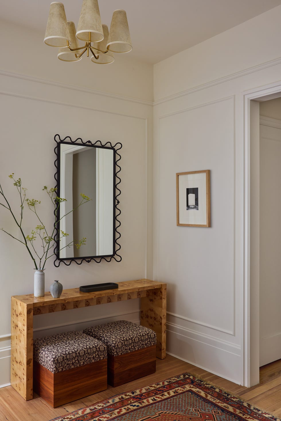 Entryway with a console table, mirror, and decorative elements.