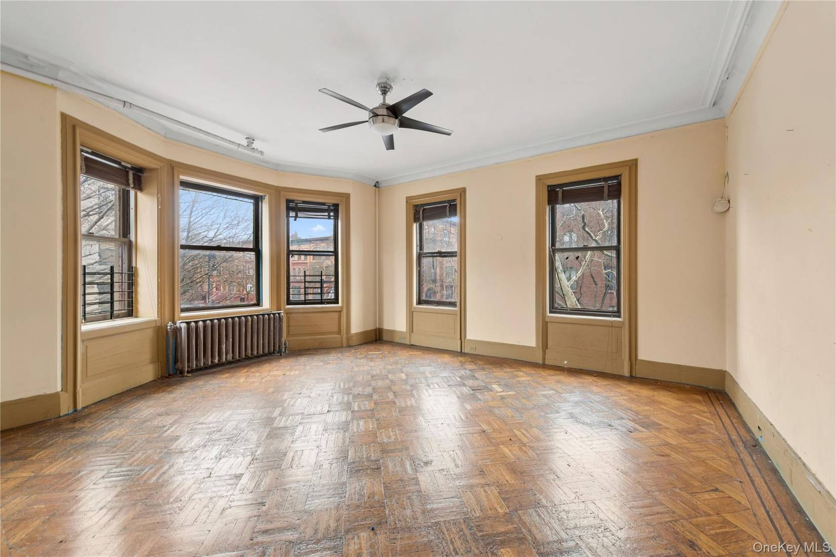 room with beige trim, wood floor