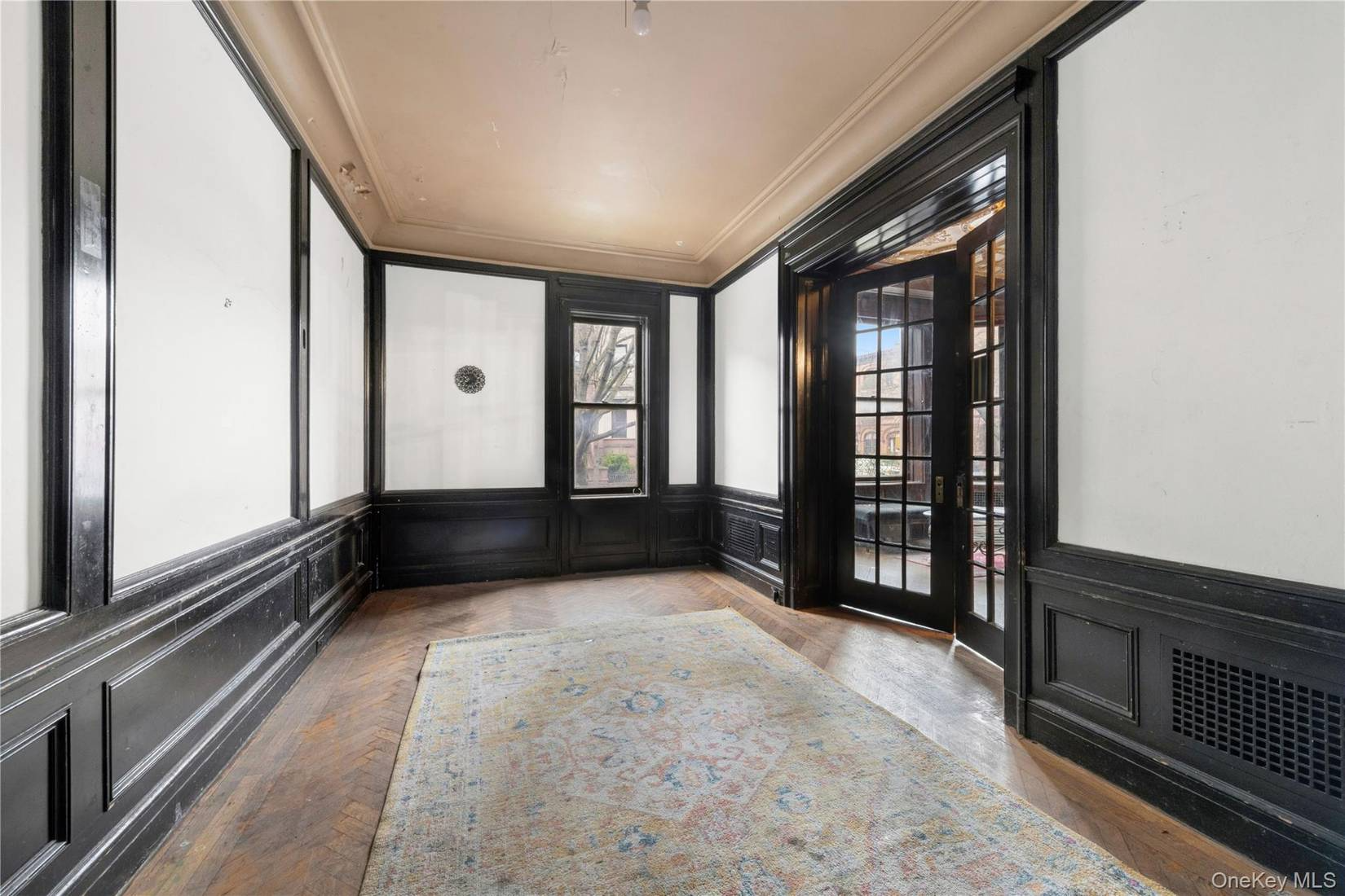 room with wainscoting, french doors