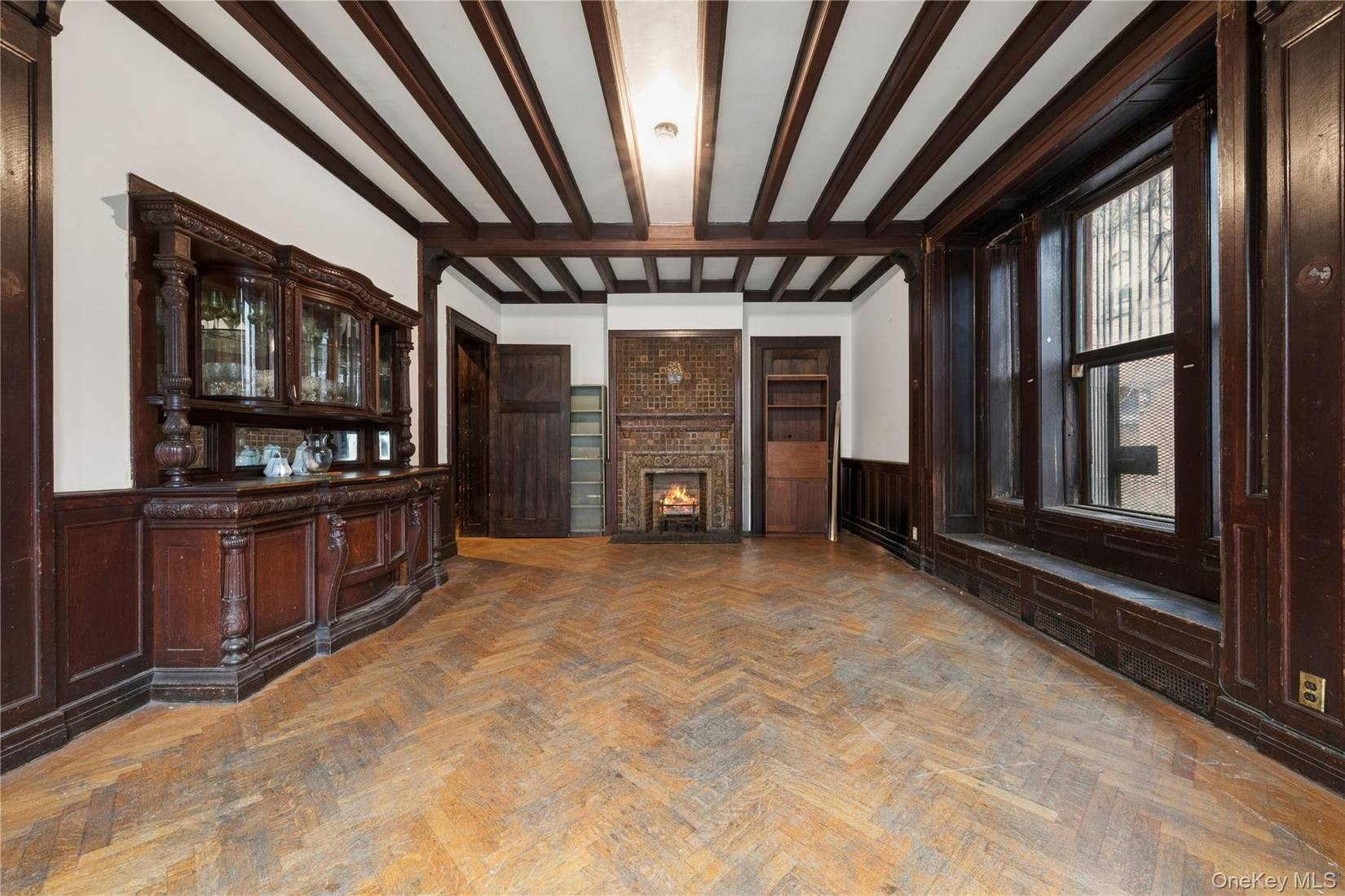 dining room with built-in buffet, window seat, beamed ceiling
