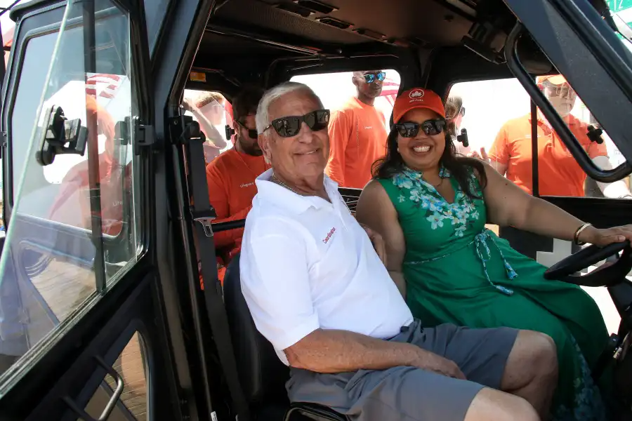 people posing in a vehicle