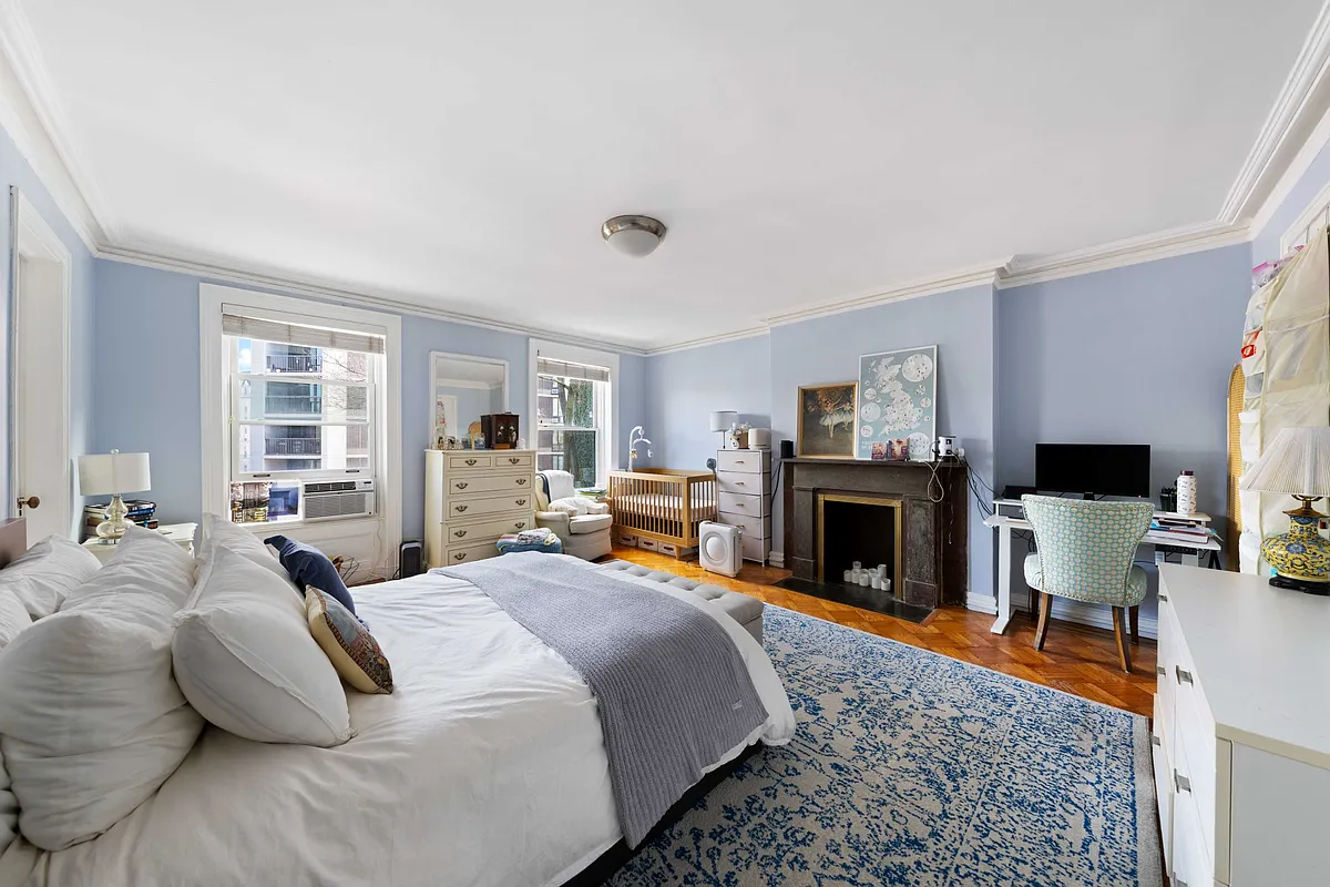 bedroom with mantel, blue painted walls