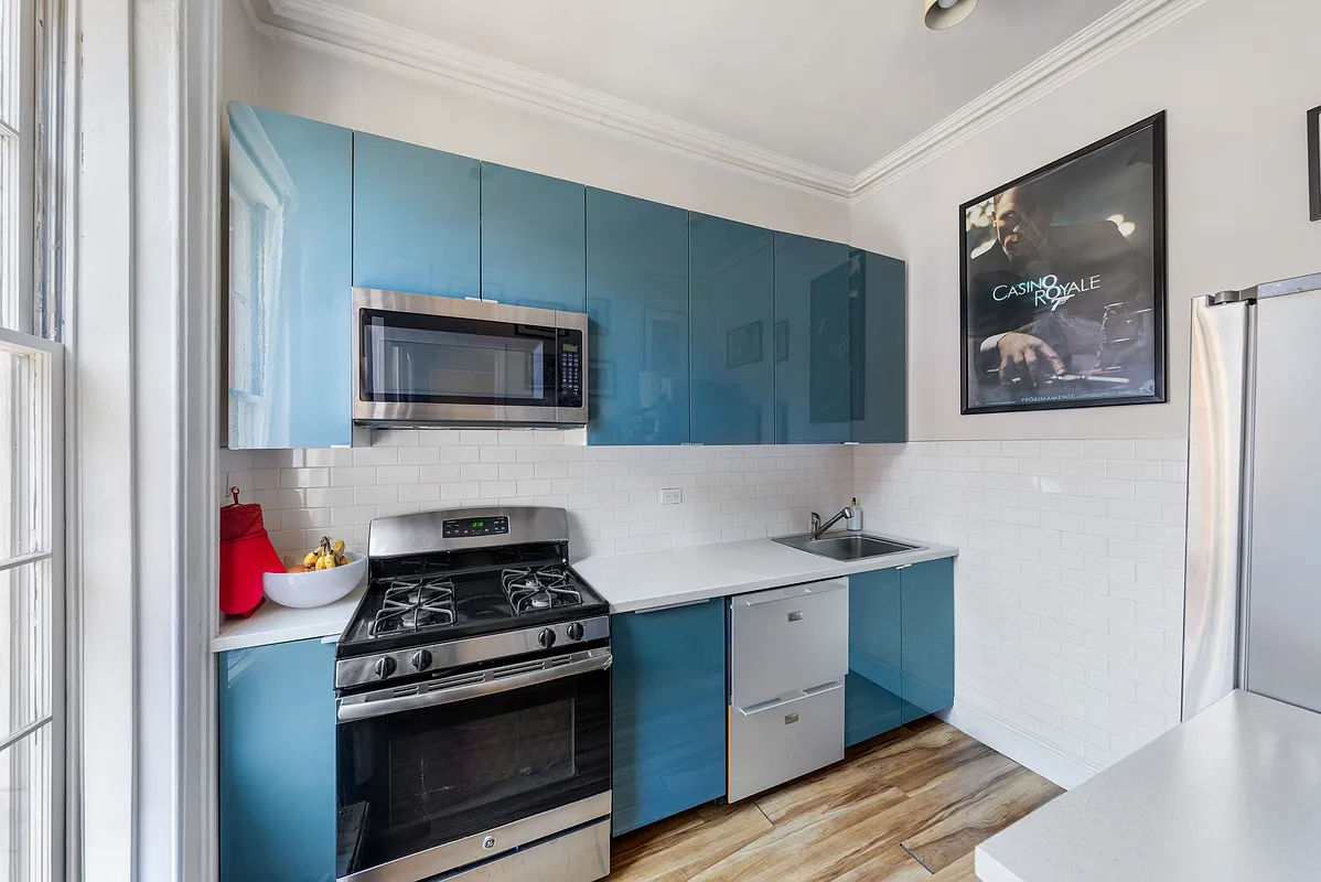 apartment kitchen with blue cabinets