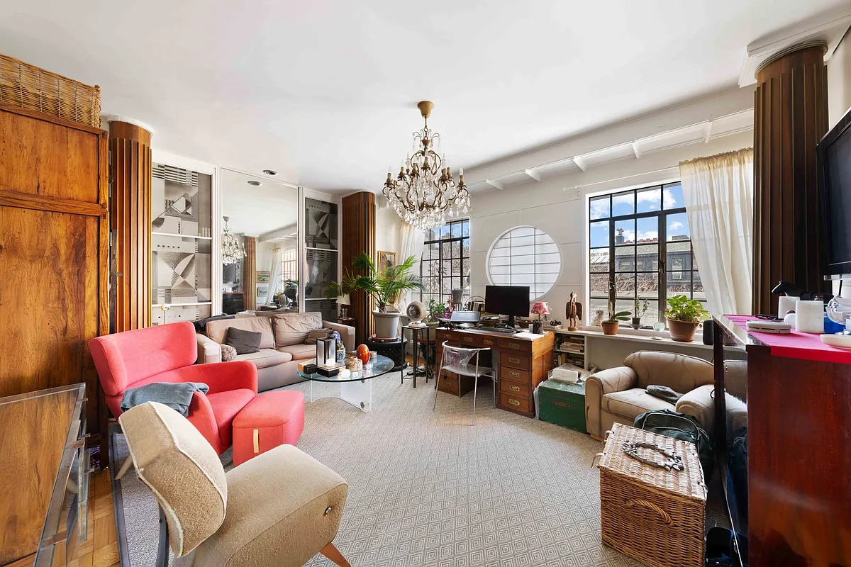 top floor apartment living room with porthole window