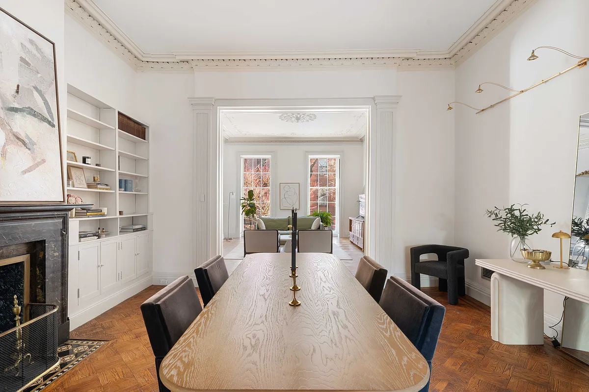 dining room with wood floor, plasterwork, mantel