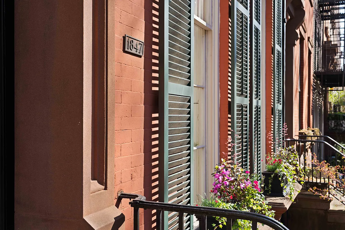 brick rowhouse with shutters