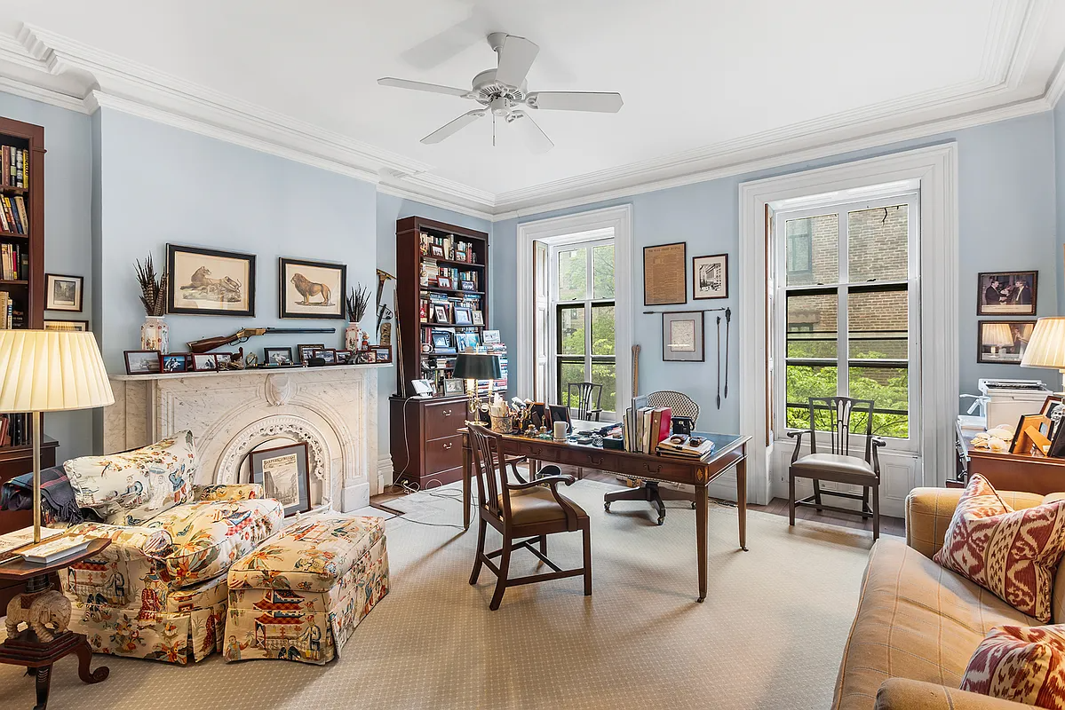 bedroom set up as a study with mantel, blue walls