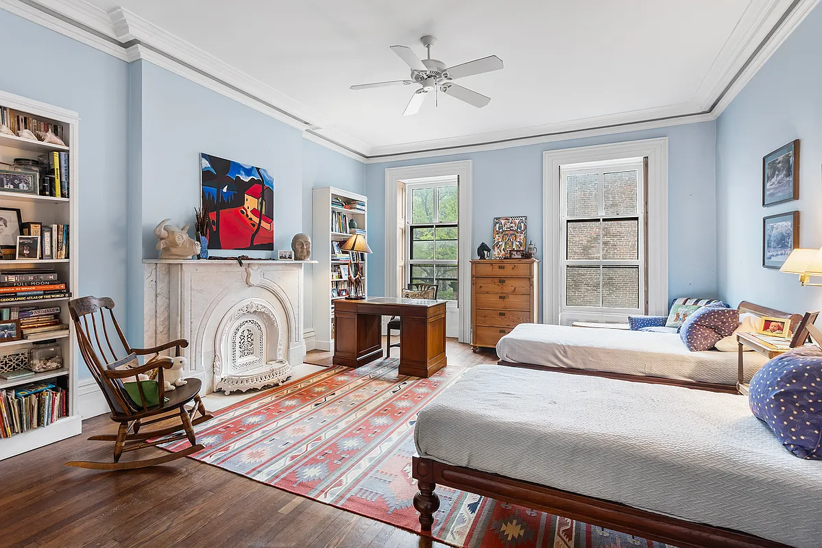 bedroom with blue walls, white marble mantel