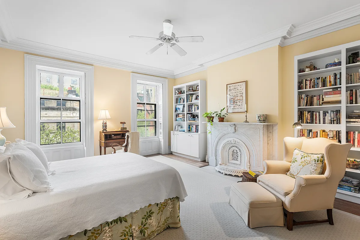 bedroom with marble mantel, yellow walls