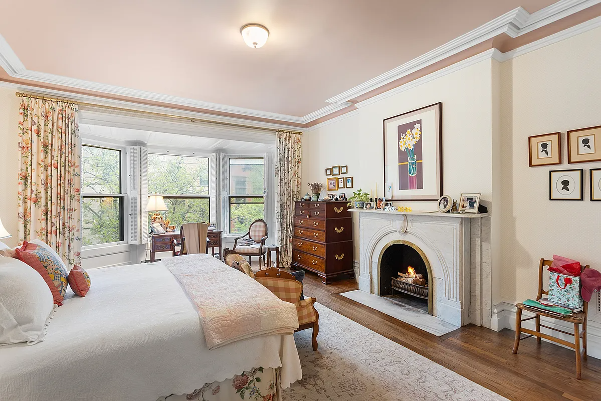 bedroom with mantel, bay window