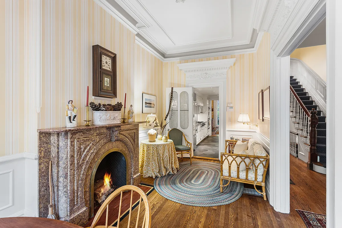narrow breakfast room with mantel, view into kitchen