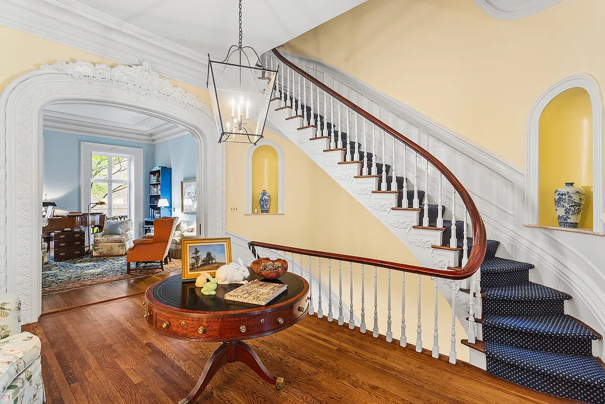 stair hall with curved stair, blue walls