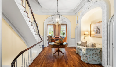 brooklyn heights - hall with curved stair rail and a niche framed with ornamental details