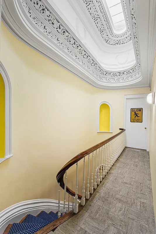 stair hall with plasterwork, yellow walls