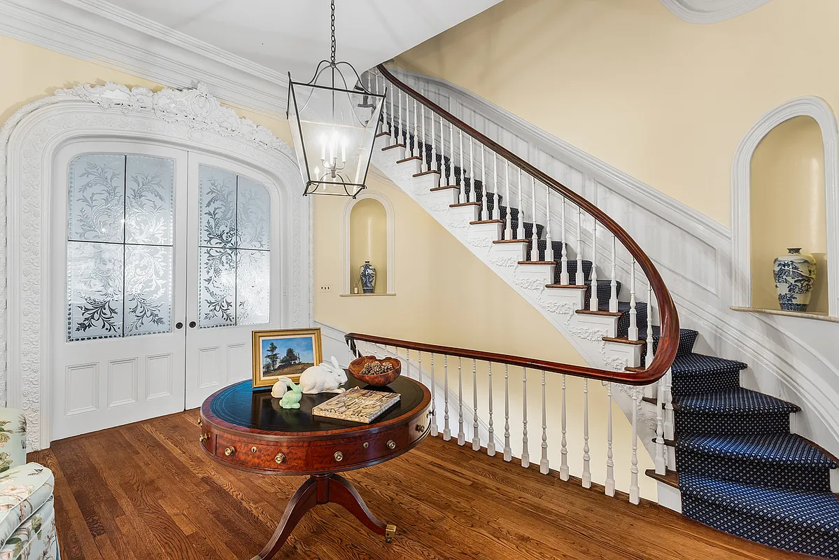 stair hall with yellow walls pocket doors with glass