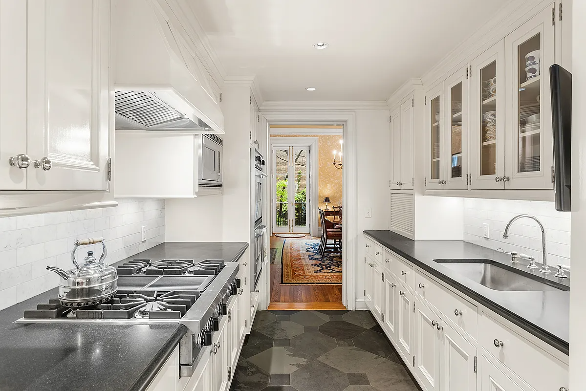 galley kitchen with white cabinets