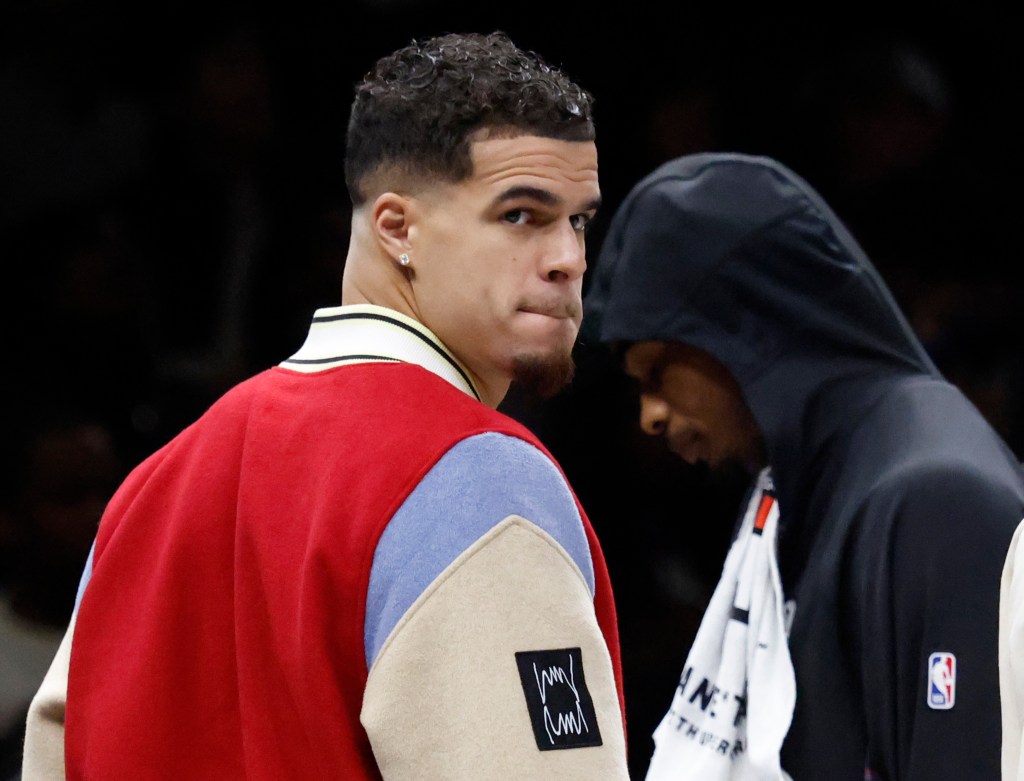 Brooklyn Nets player Michael Porter Jr. on the bench during a game.