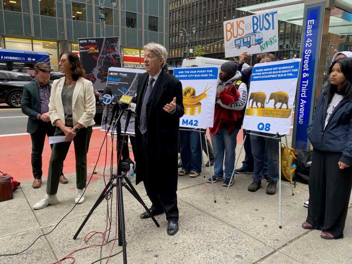 group of people at a podium with signs outside