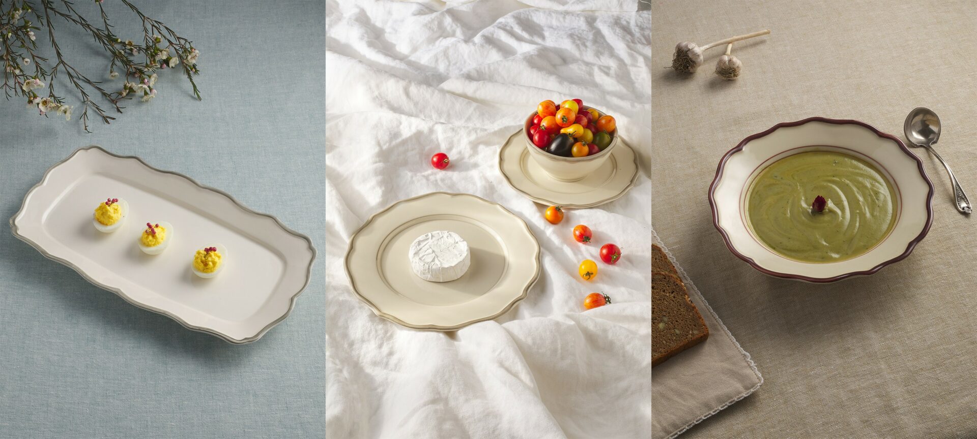 Three plates with desserts and a bowl of fruit on a white tablecloth, with scattered candies and a small jar.