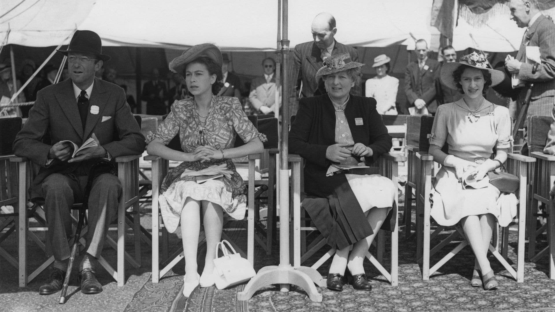 Black and white image of Princess Elizabeth and Princess Margaret sitting with the Duke and Duchess of Beaufort