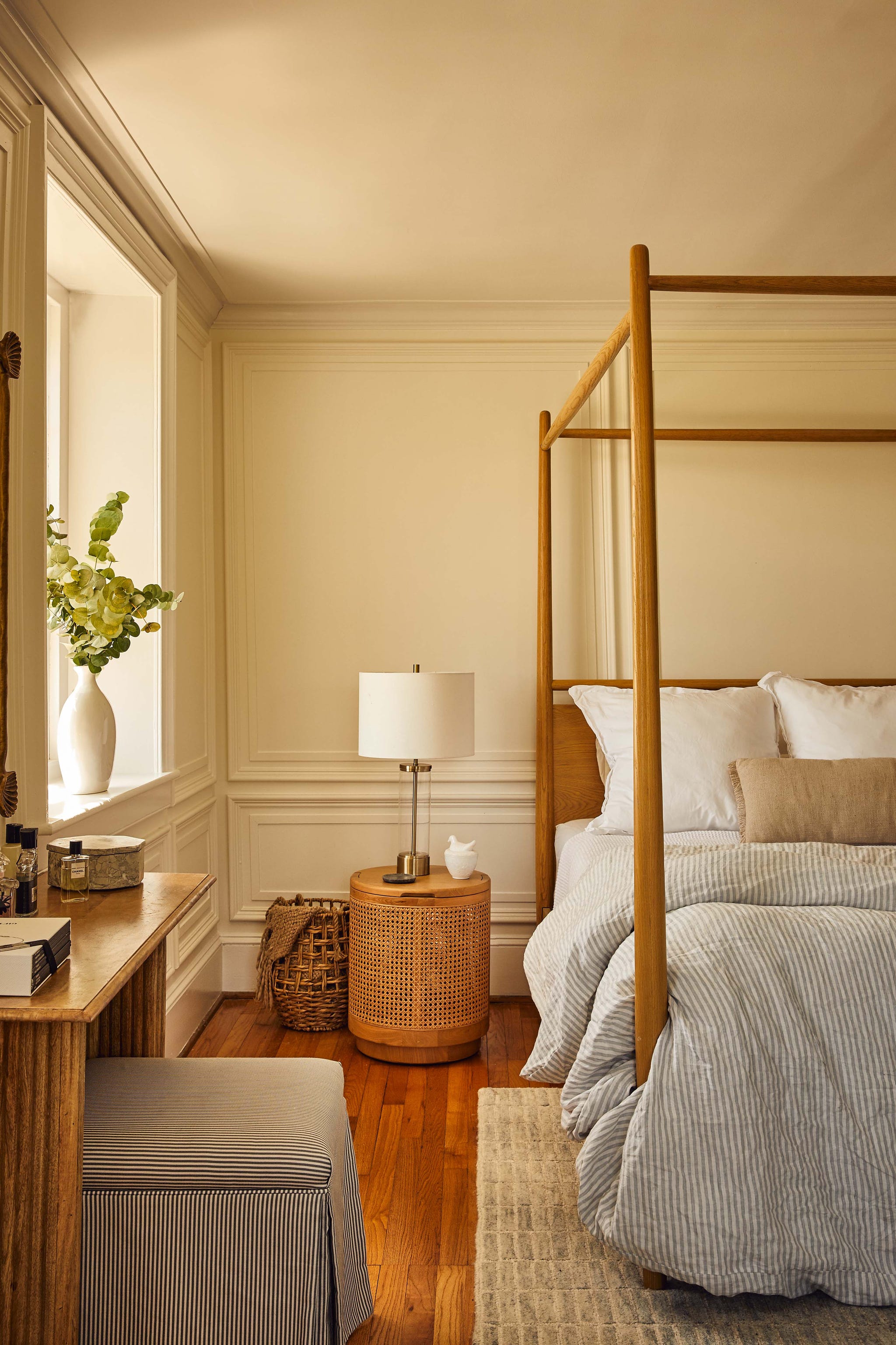 Modern bedroom with a four-poster bed and wooden furniture. Modern bedroom with a four-poster bed and wooden furniture.