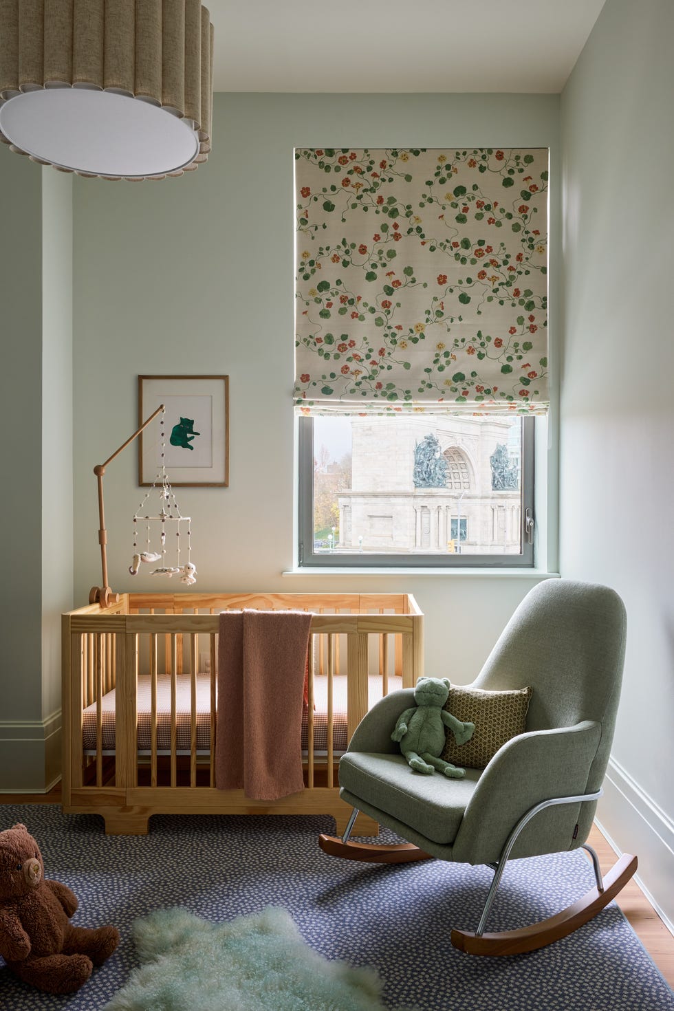 Cozy nursery room with a crib and rocking chair.