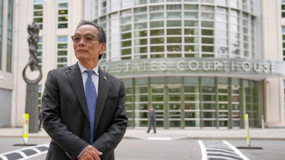 Lu Jianwang waits to enter a federal courthouse in New York, Wednesday, May 6, 2026.