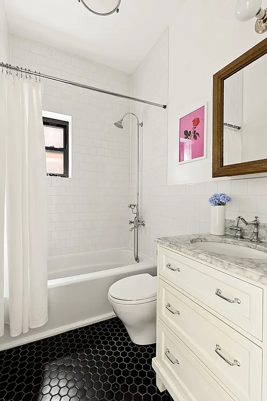 bathroom with black hex tile floor