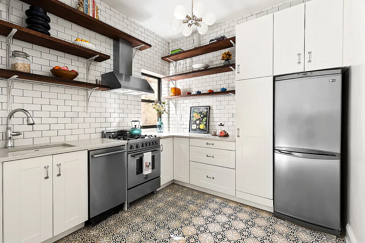 kitchen with graphic tile floor, white cabinets