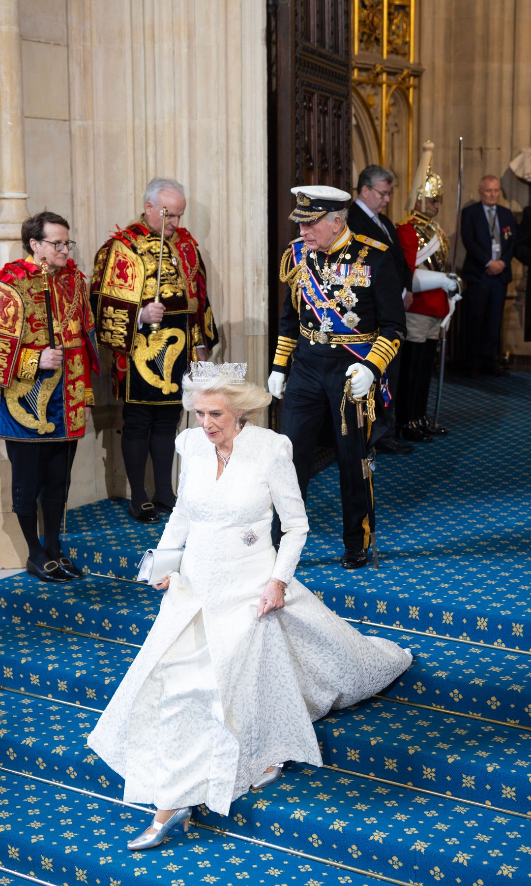 The photo makes Queen Camilla look like Cinderella, rushing down the stairs
