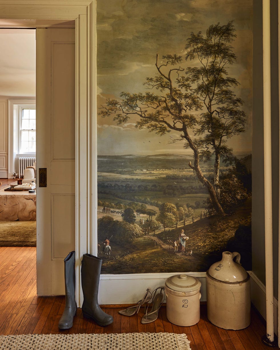 Interior space featuring a painted mural, footwear, and decorative items. Interior space featuring a painted mural, footwear, and decorative items.