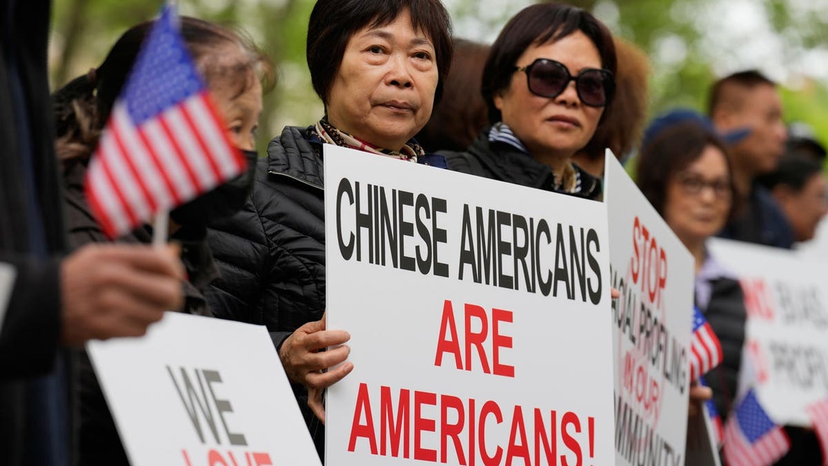 Supporters of Lu Jianwang stand outside a federal courthouse before the opening of his trial in New York