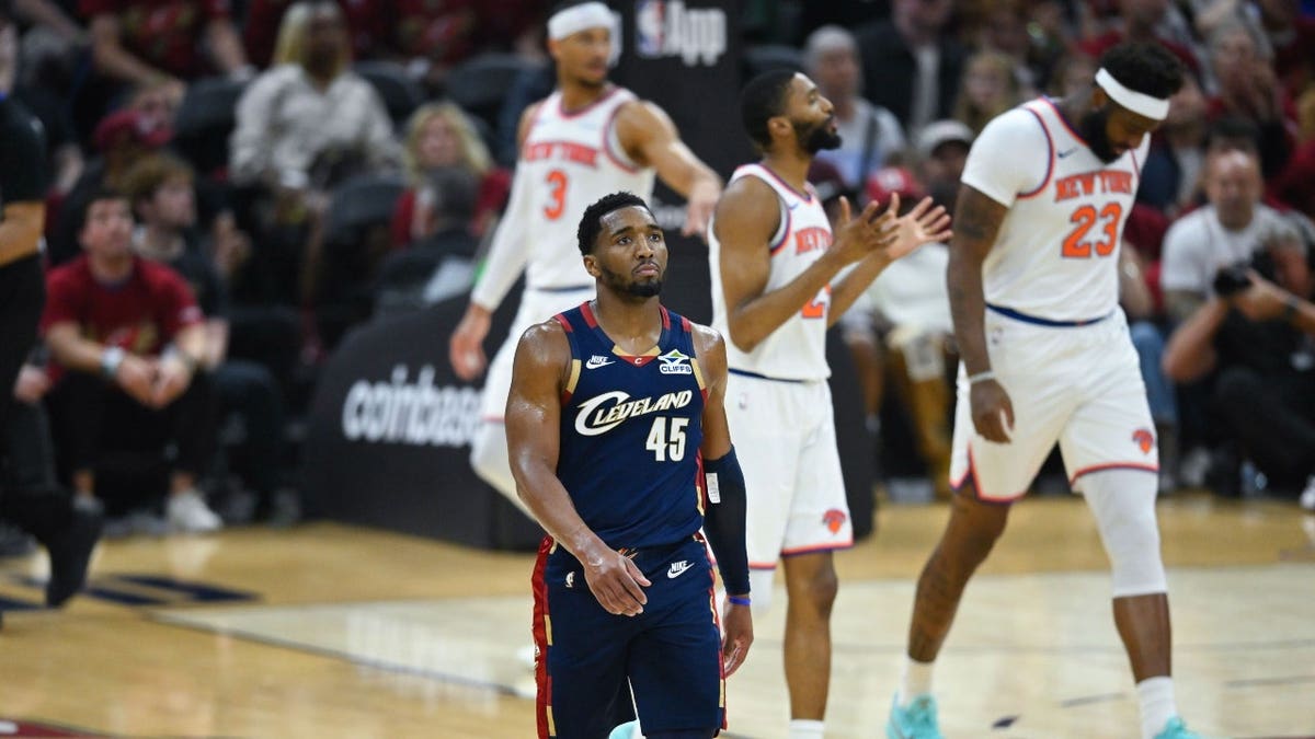 Cleveland Cavaliers guard Donovan Mitchell reacting after a turnover during a basketball game.