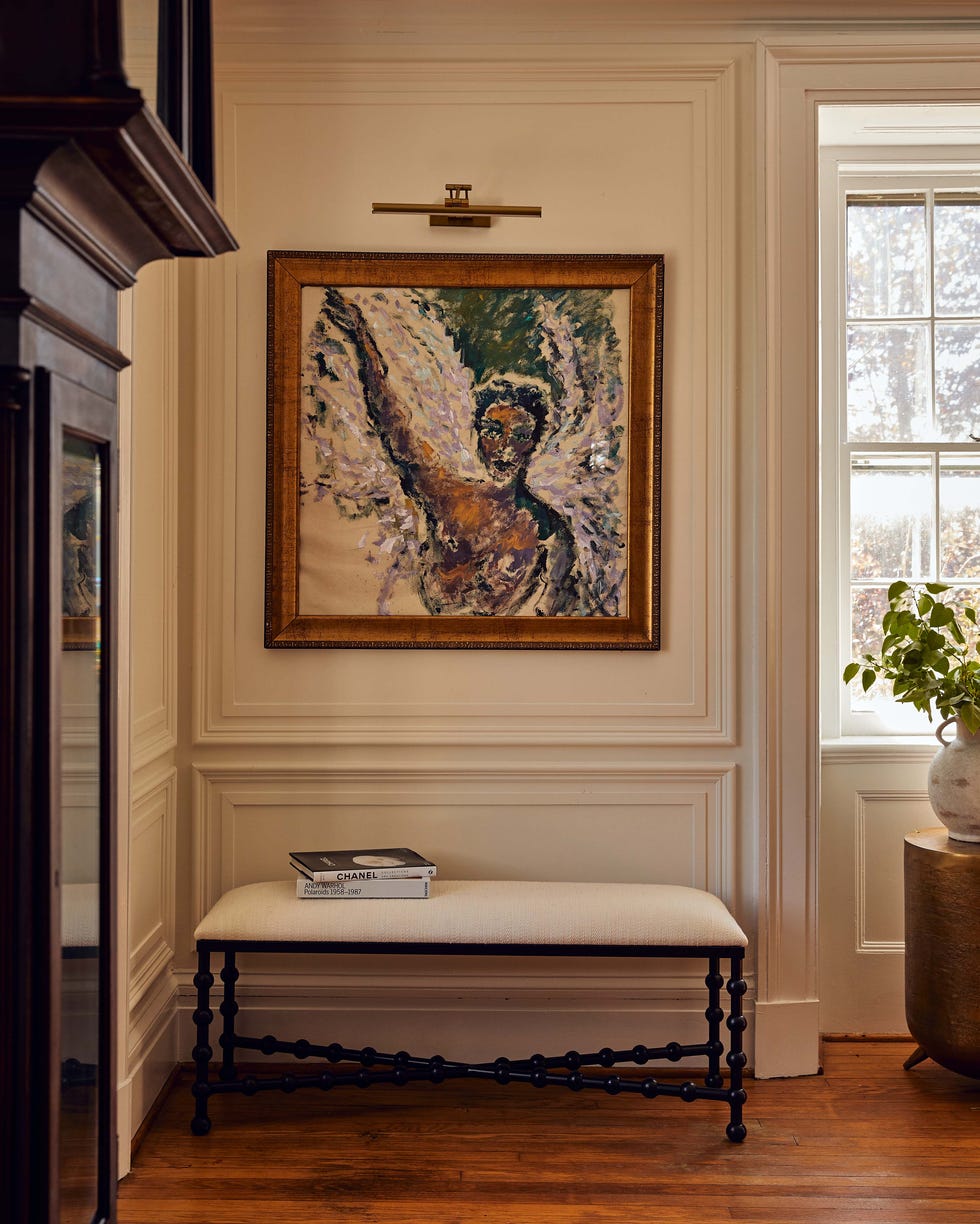 Artistic depiction of an angel with a nearby seating area and decor.