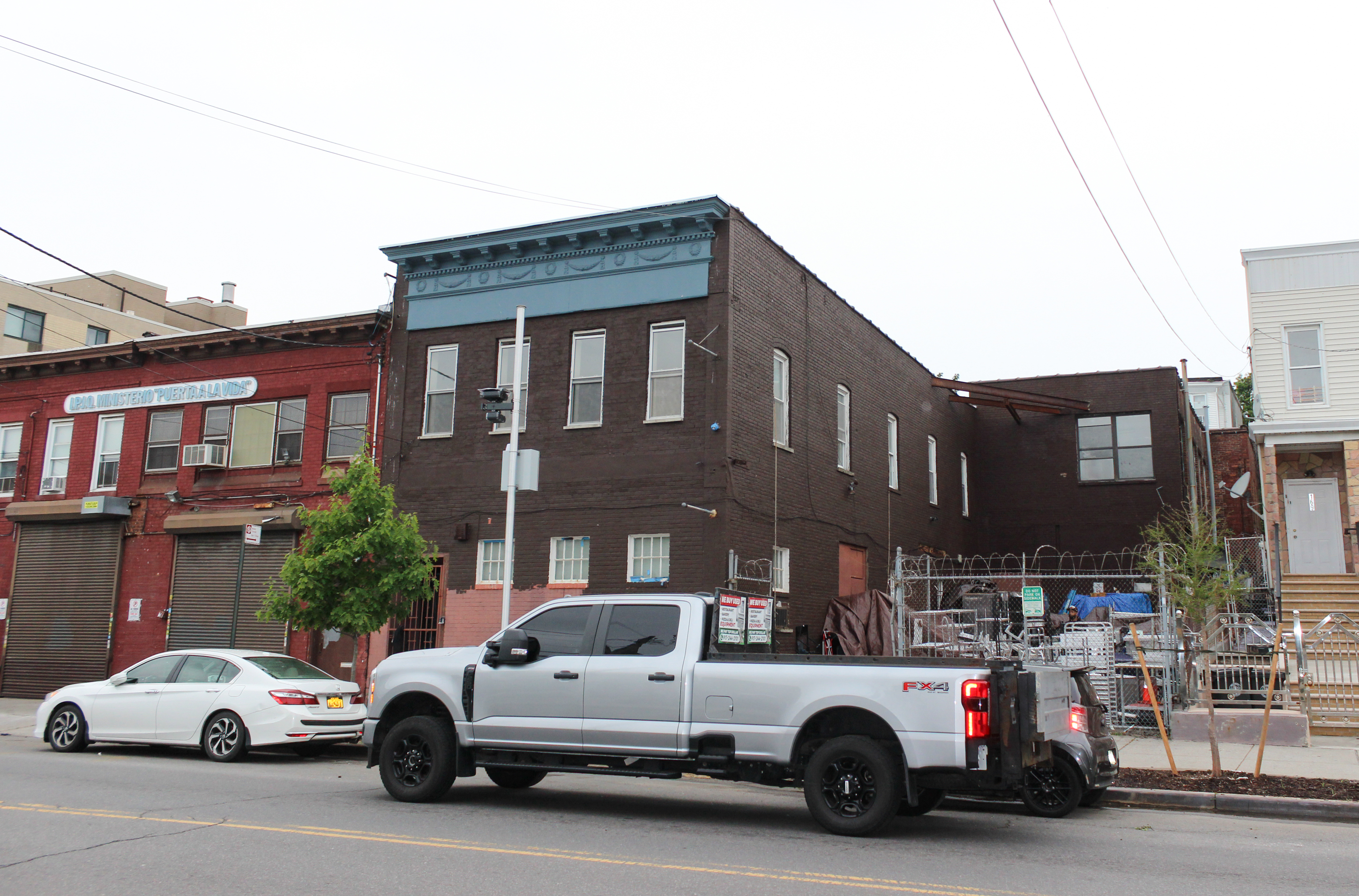 a two story building with a blue cornice