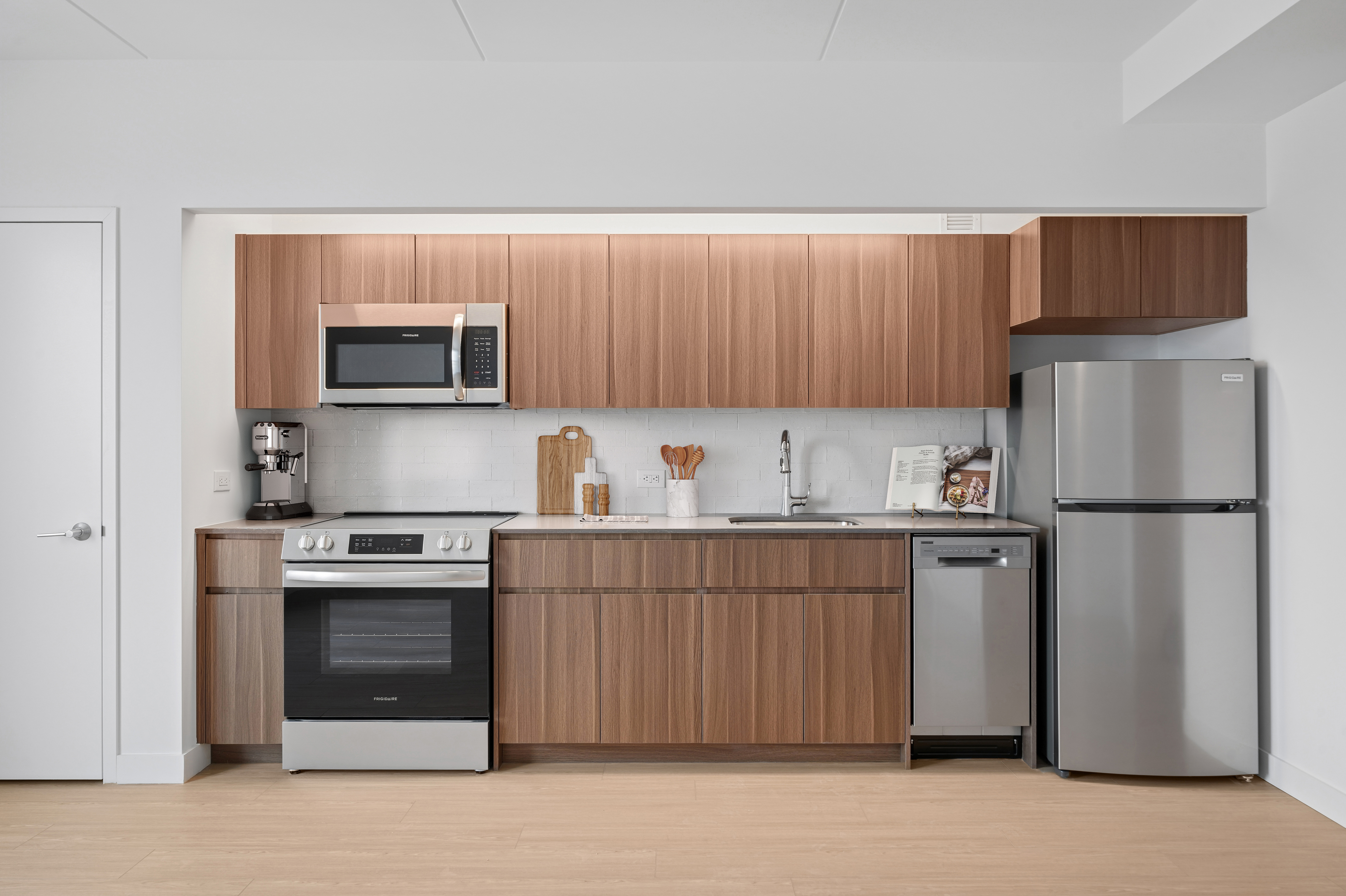 rendering of a kitchen with wood cabinets, stainless steel appliances