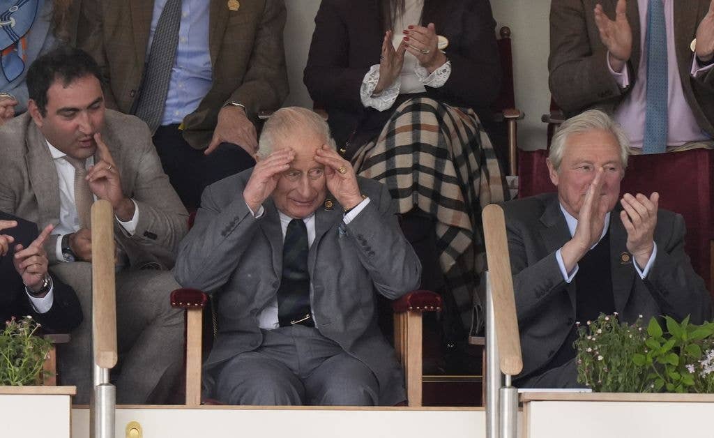 King Charles with his head in his hands while watching the Royal Windsor Horse Show