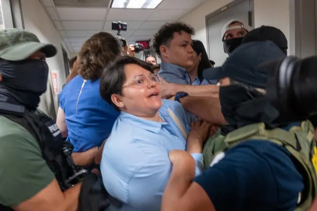 A Paraguayan woman whose relative was detained is surrounded by federal agents at the Jacob K. Javits Federal Building on July 16, 2025, in New York City. Various council members and a state senator attended immigration hearings and observed Immigration and Customs Enforcement as they continued their stepped-up tactics of detaining people during routine check-ins or showing up to court for their immigration hearings.